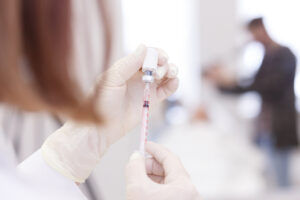 An ophthalmologist preparing a syringe for BOTOX for blepharospasm