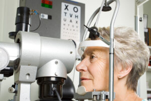 Older woman having an eye exam to check for AMD and other age-related vision changes.